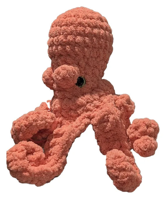 Coral crochet octopus with long curling arms