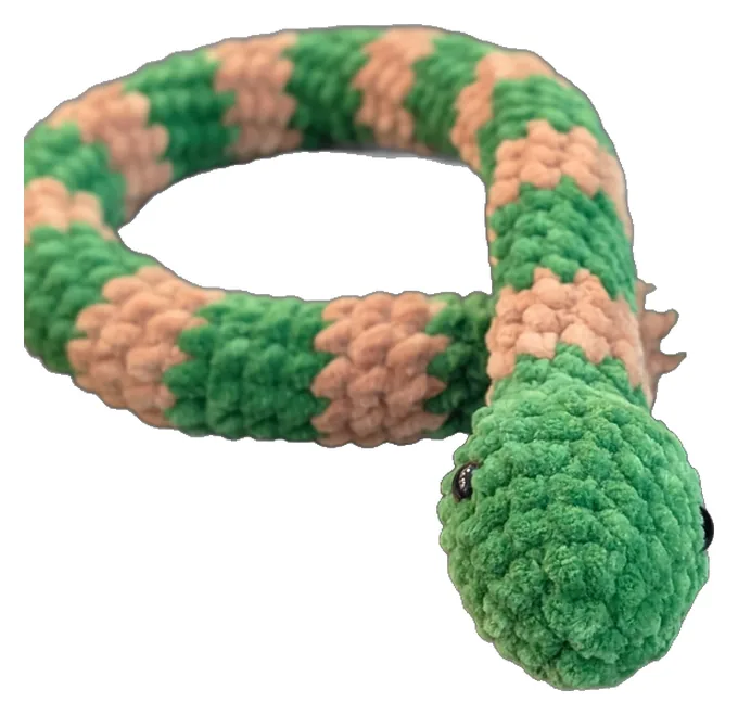 Long green crochet snake with peach stripes, curled into a loop